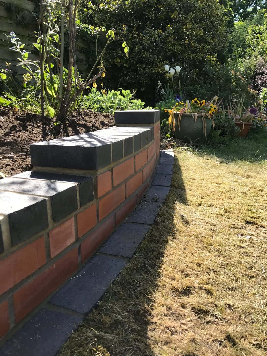 New red-brick garden wall with a brick coping