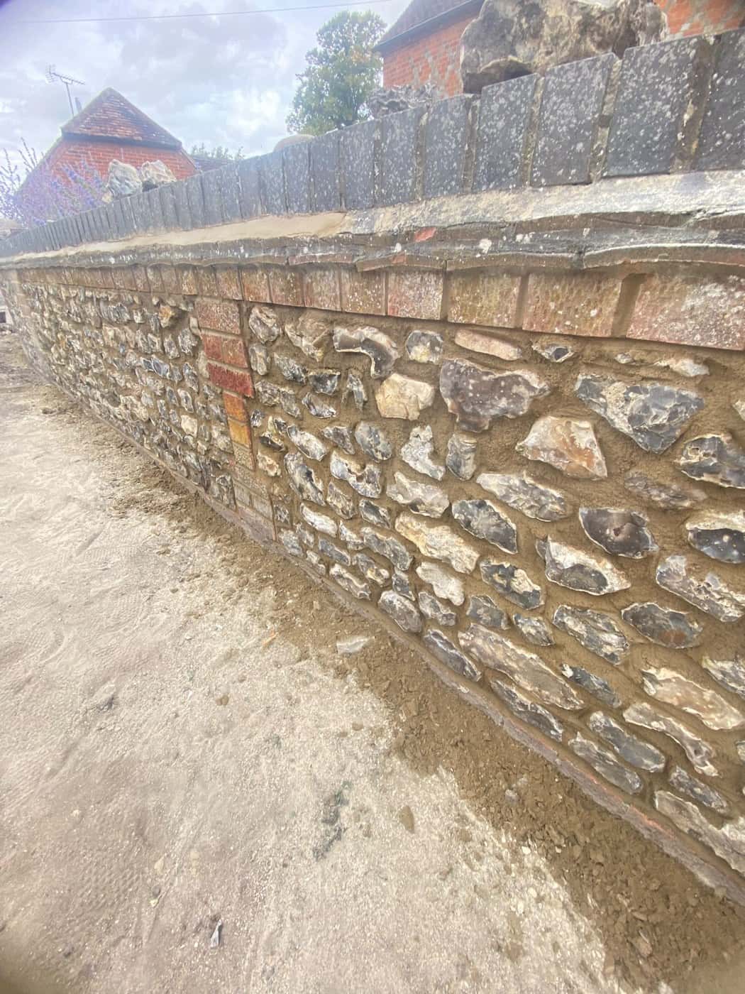 Close-up of new flintwork in a brick-banded garden wall
